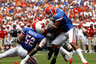 GAINESVILLE FL - SEPTEMBER 04: Armand Robinson #11 of the Miami University RedHawks is tackled by Johnathan Bostic #52 and Jeremy Brown #8 of the Florida Gators at Ben Hill Griffin Stadium on September 4 2010 in Gainesville Florida. (Photo by Sam Greenwood/Getty Images)