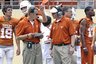 Texas' co-offensive coordinators Major Applewhite, front right, and Bryan Harsin,  front left, talk during the Texas Orange and White spring football scrimmage on Sunday, April 3, 2011, in Austin, Texas. The Orange team won 27-7. (AP Photo/Michael Thomas)