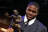 FILE - In this Dec. 10, 2005, file photo,  Southern California tailback Reggie Bush picks up the Heisman Trophy after being announced as the winner of the award in New York. Bush said Tuesday, Tuesday, Sept. 14, 2010, that he is forfeiting his Heisman Trophy. (AP Photo/Julie Jacobson, File)