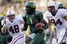 Oregon quarterback Darron Thomas (1) carries the ball as he is pursued by Stanford's Owen Marecic (48) and Oregon defensive tackle Axel McQuaw (94) in the first half of an NCAA college football game Saturday, Oct. 2, 2010, in Eugene, Ore.  Oregon defeated Stanford 52-31. (AP Photo/Rick Bowmer)
